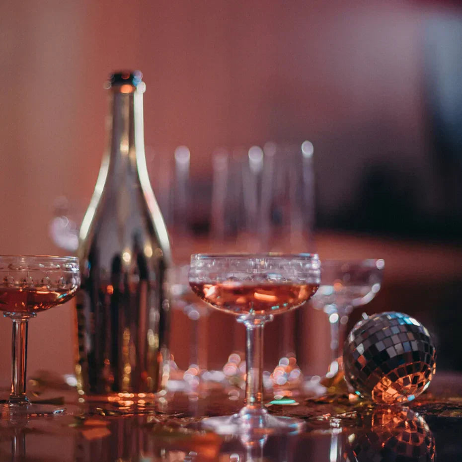 Bottle of champagne and coupe glasses