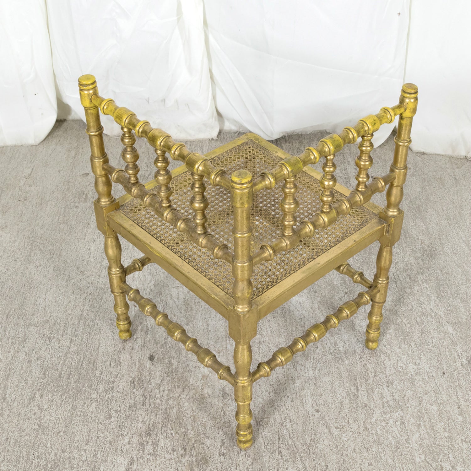 Early 20th Century French Carved Faux Bamboo Painted and Parcel Gilt Corner Chair with Cane Seat