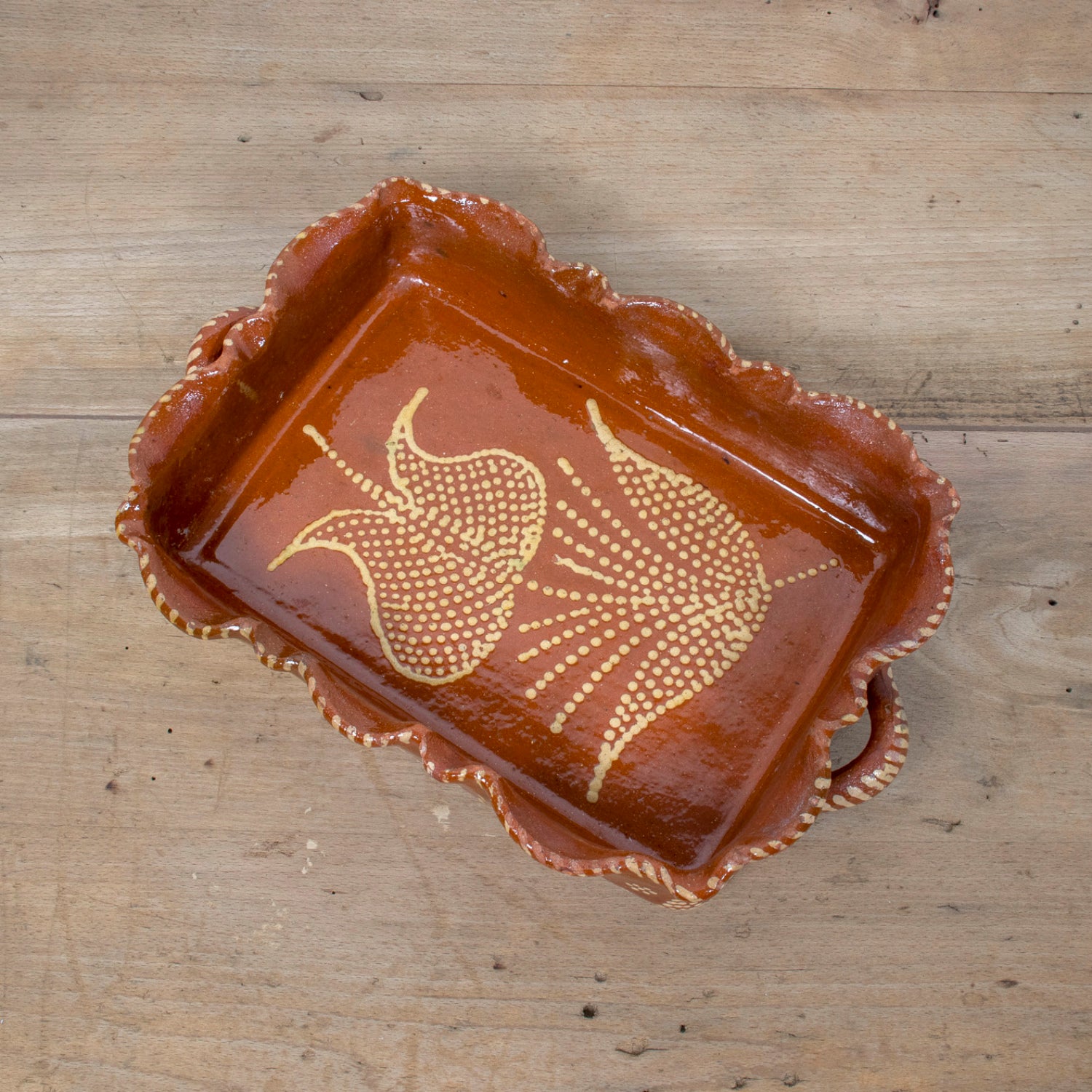 19th Century Portuguese Red Slipware Baking Dish with Tulip Design and Ruffled Edge