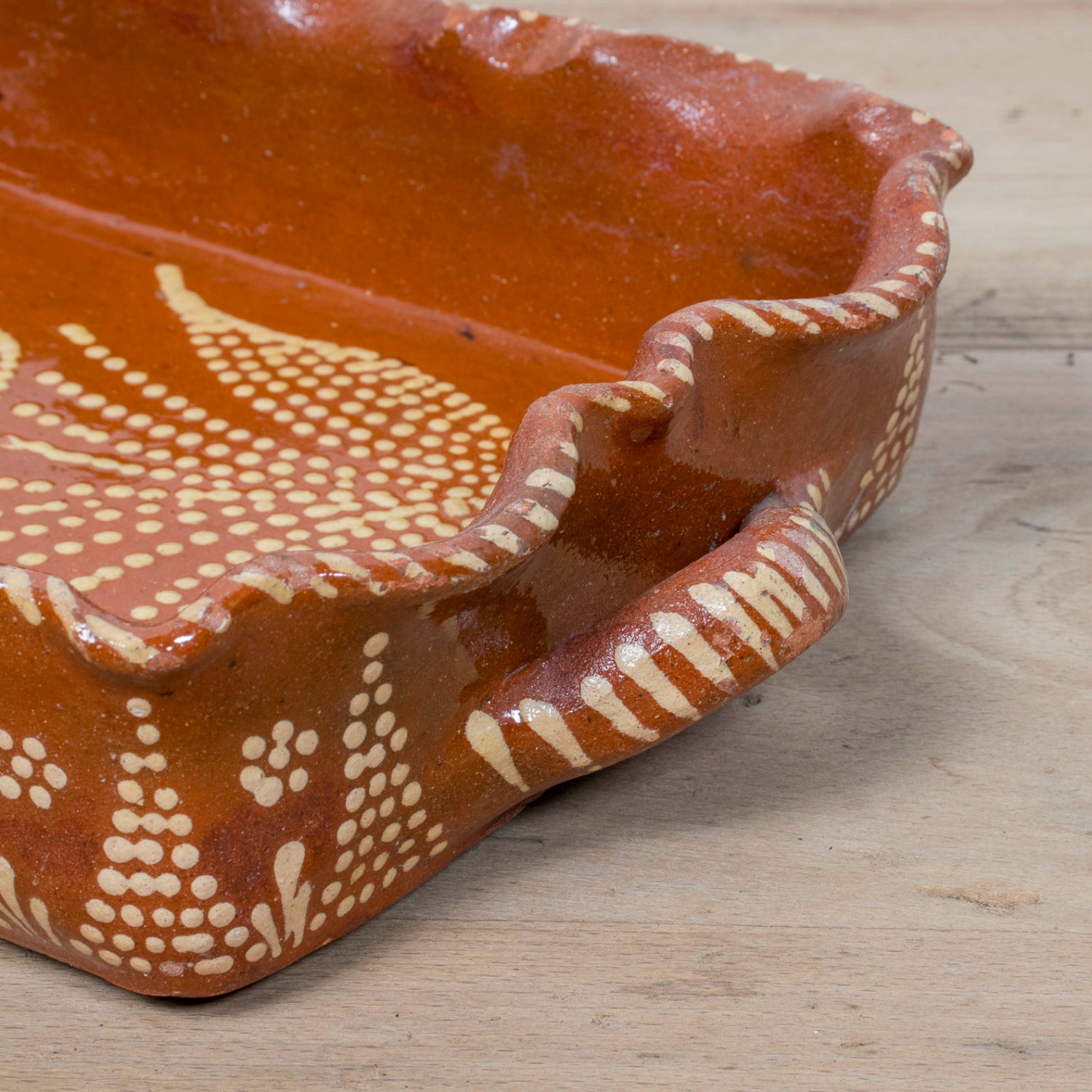 19th Century Portuguese Red Slipware Baking Dish with Tulip Design and Ruffled Edge