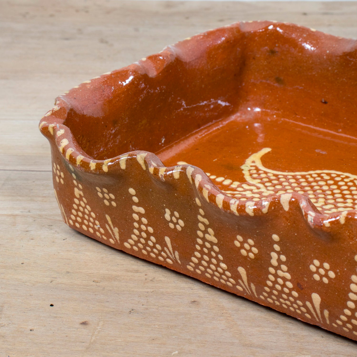 19th Century Portuguese Red Slipware Baking Dish with Tulip Design and Ruffled Edge