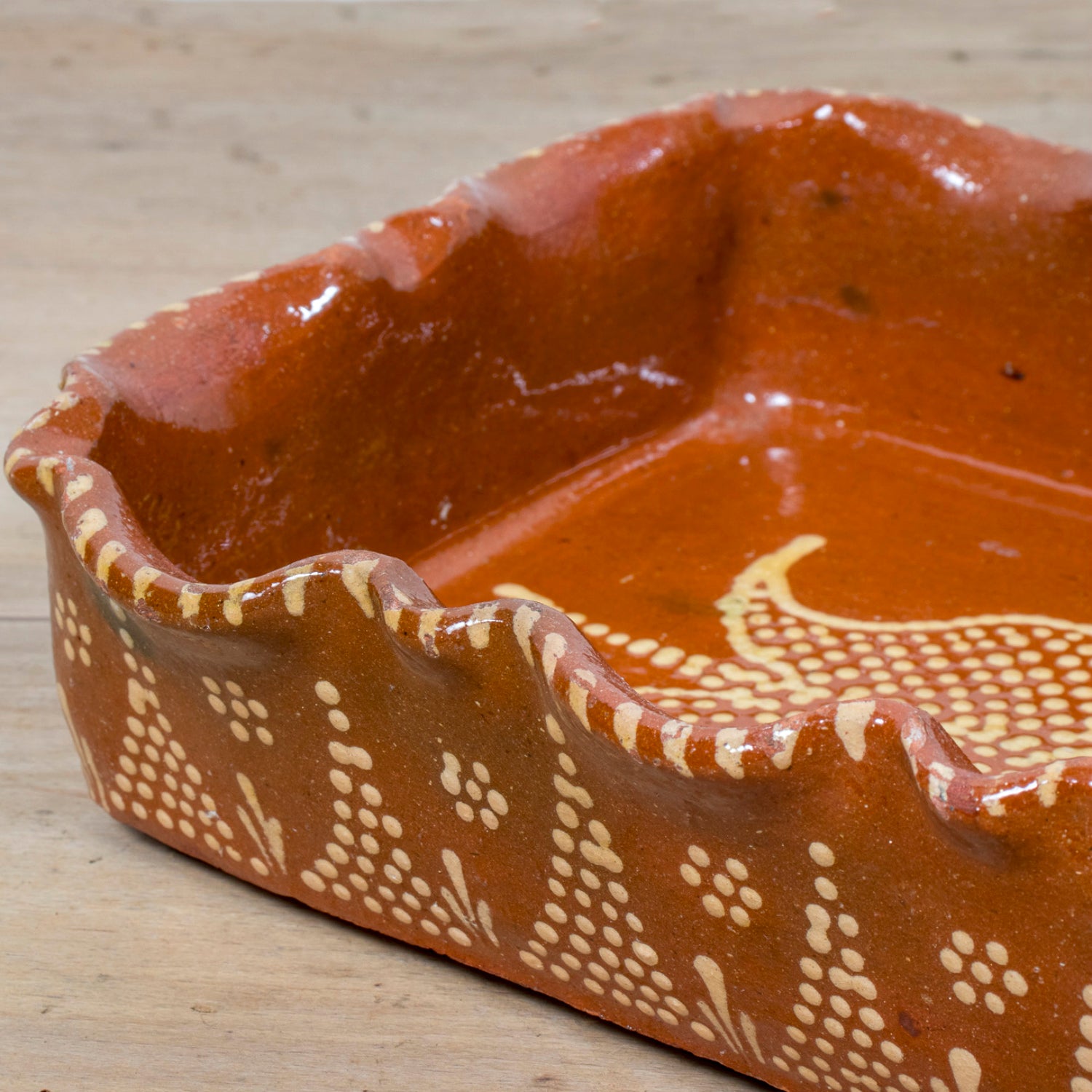 19th Century Portuguese Red Slipware Baking Dish with Tulip Design and Ruffled Edge