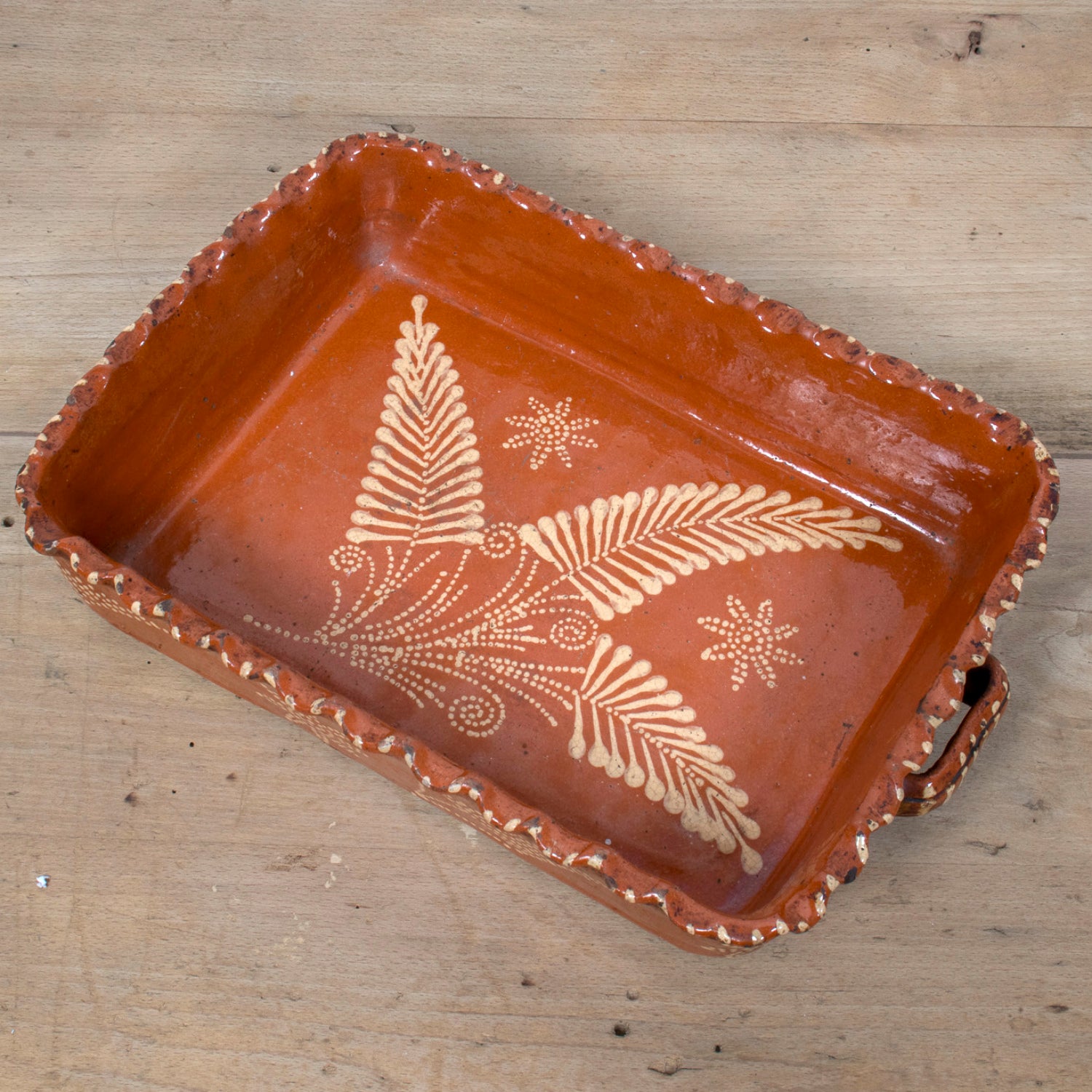 19th Century Portuguese Red Slipware Baking Dish with Fern Leaf Design and Ruffled Edge