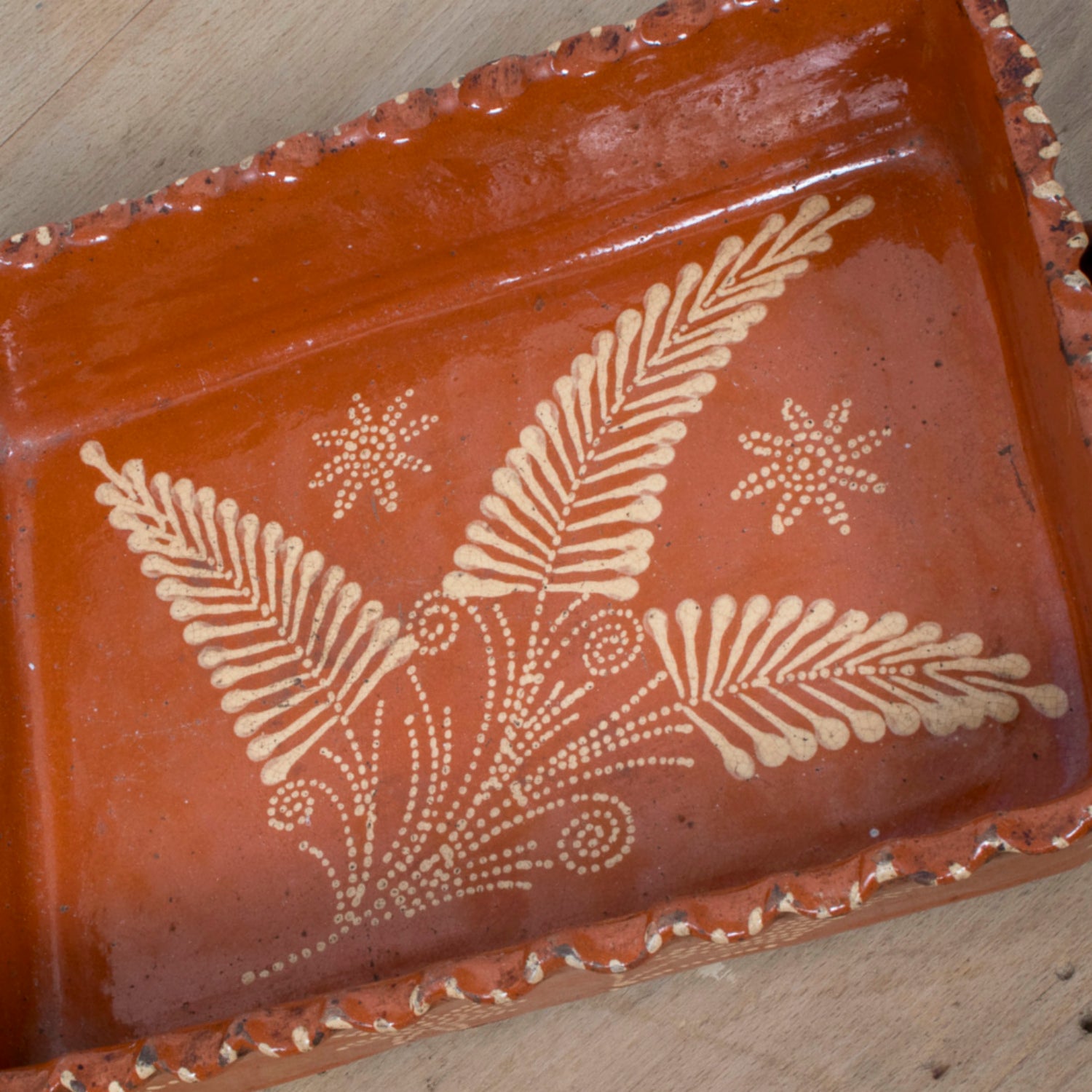 19th Century Portuguese Red Slipware Baking Dish with Fern Leaf Design and Ruffled Edge
