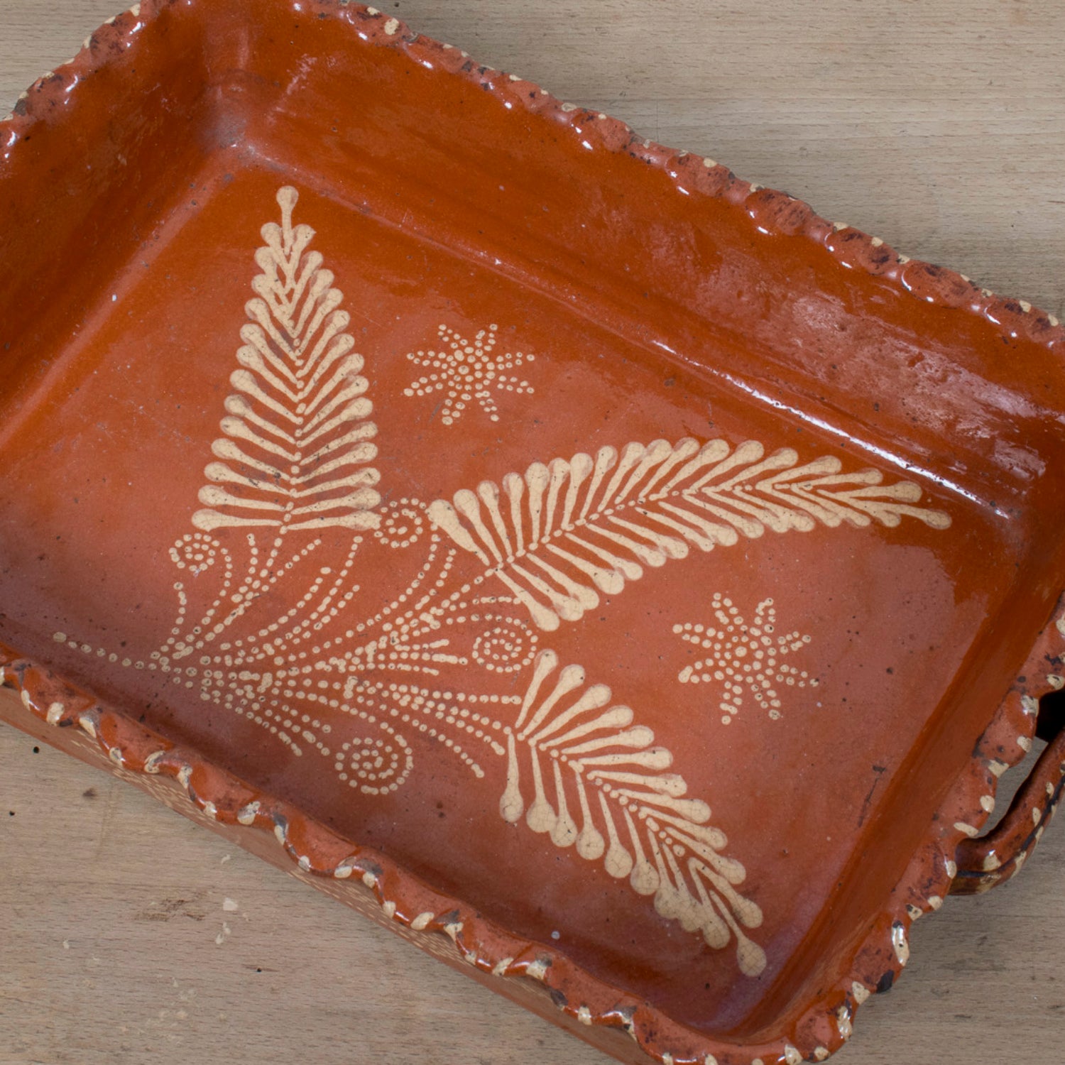 19th Century Portuguese Red Slipware Baking Dish with Fern Leaf Design and Ruffled Edge