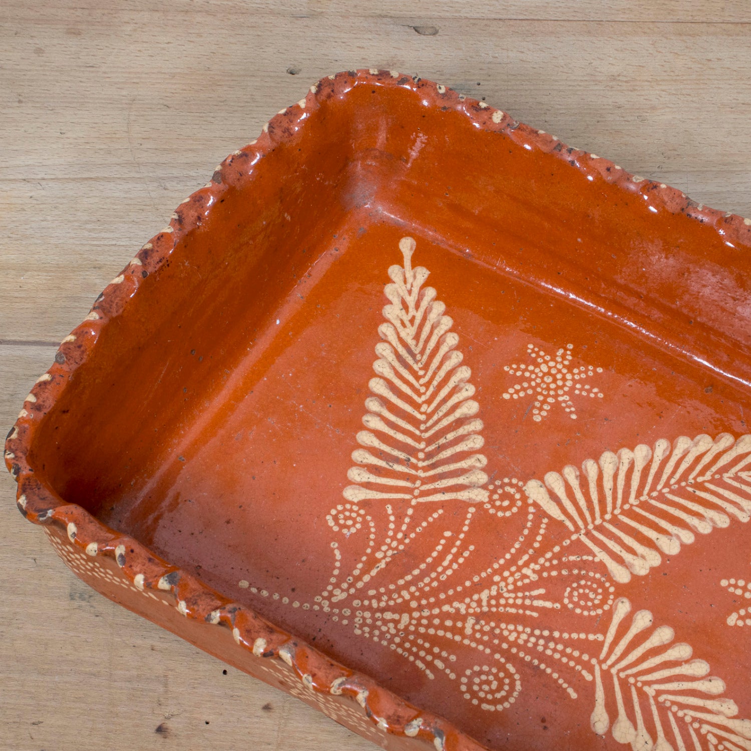 19th Century Portuguese Red Slipware Baking Dish with Fern Leaf Design and Ruffled Edge