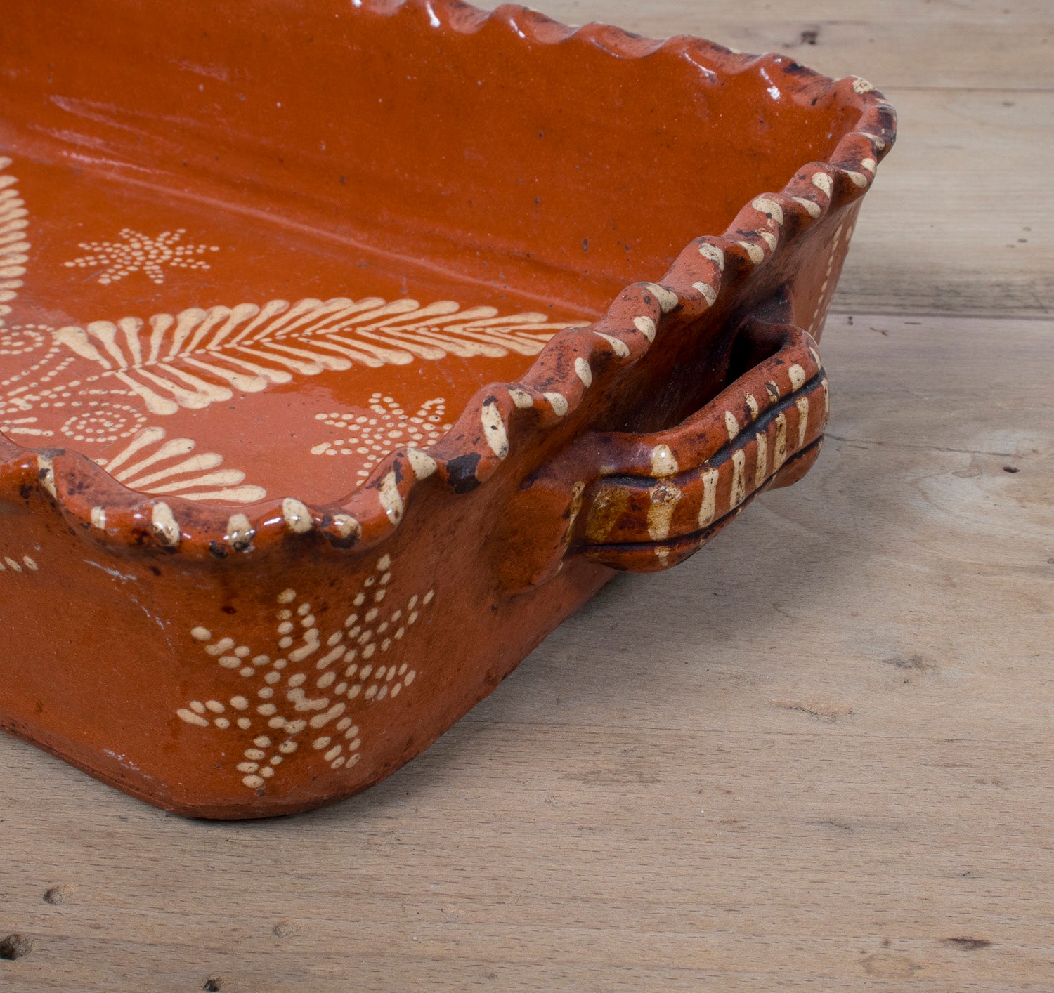 19th Century Portuguese Red Slipware Baking Dish with Fern Leaf Design and Ruffled Edge