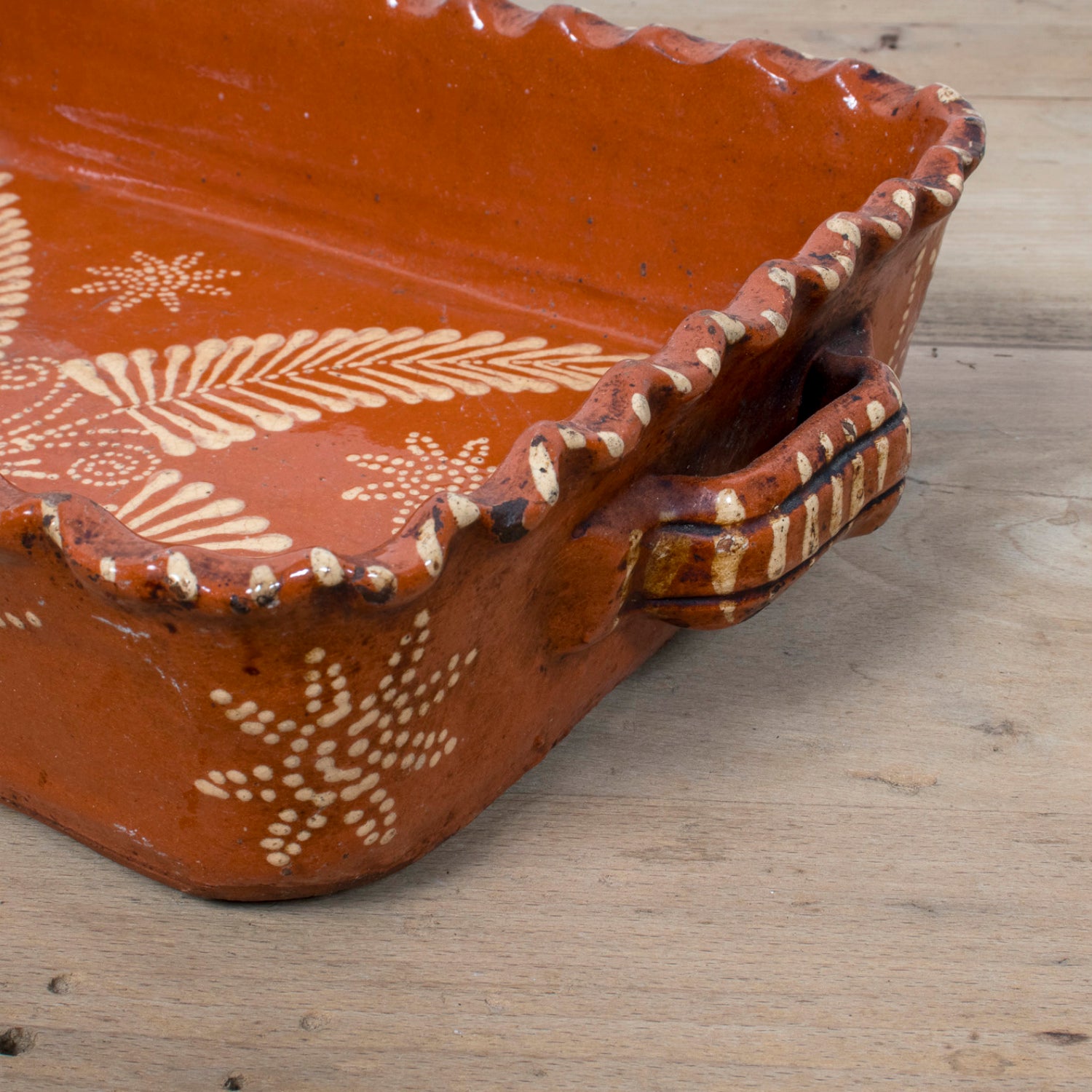19th Century Portuguese Red Slipware Baking Dish with Fern Leaf Design and Ruffled Edge
