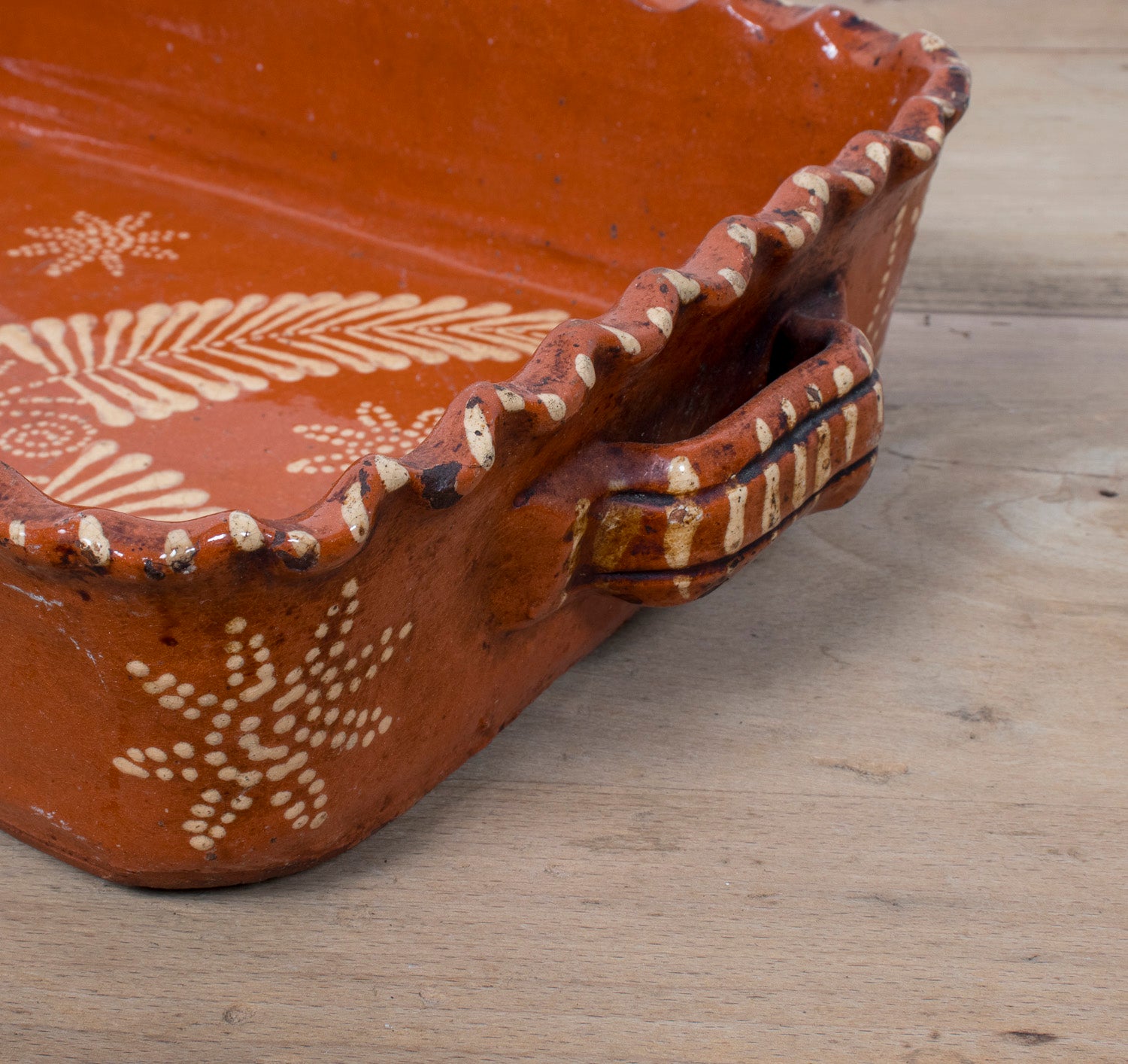 19th Century Portuguese Red Slipware Baking Dish with Fern Leaf Design and Ruffled Edge