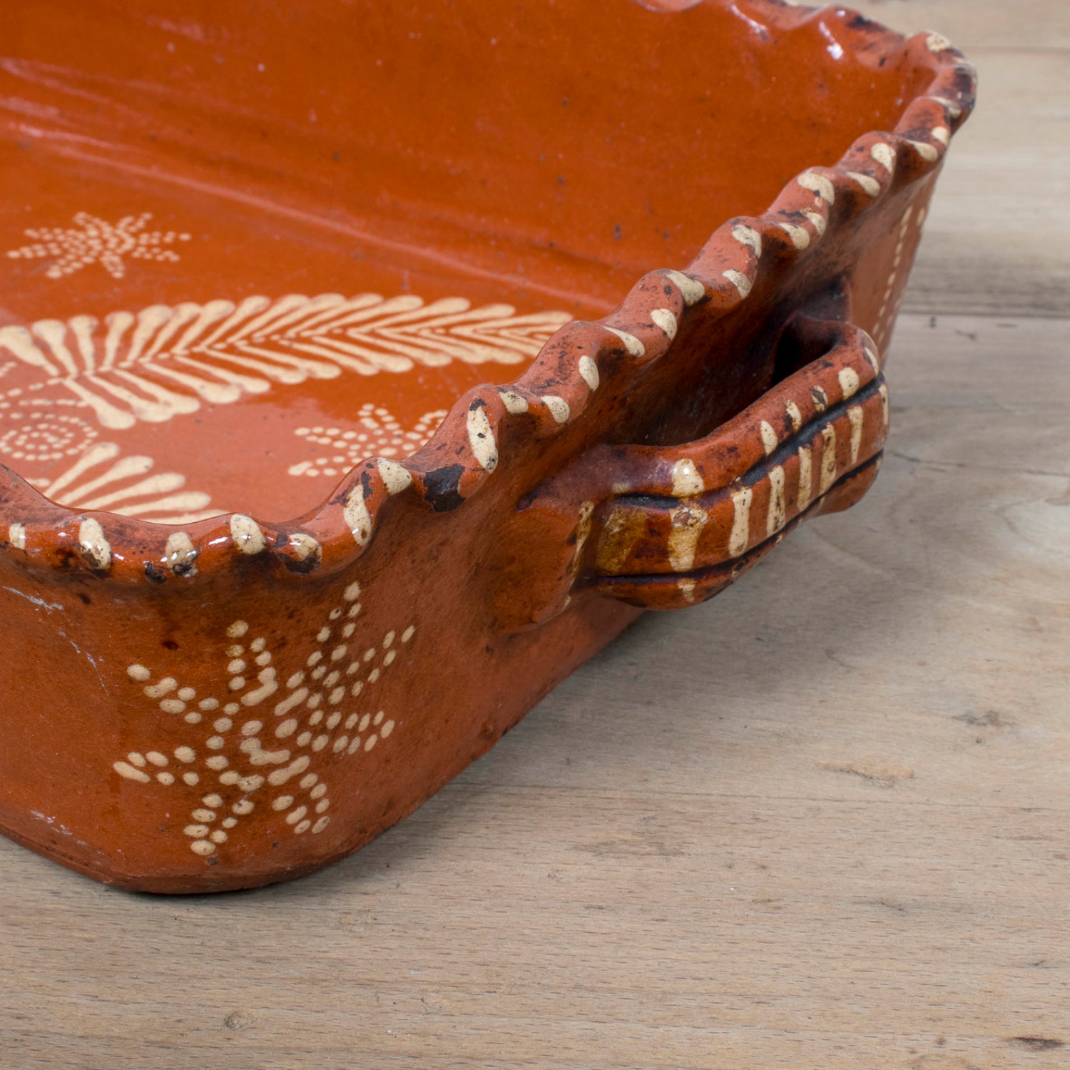 19th Century Portuguese Red Slipware Baking Dish with Fern Leaf Design and Ruffled Edge