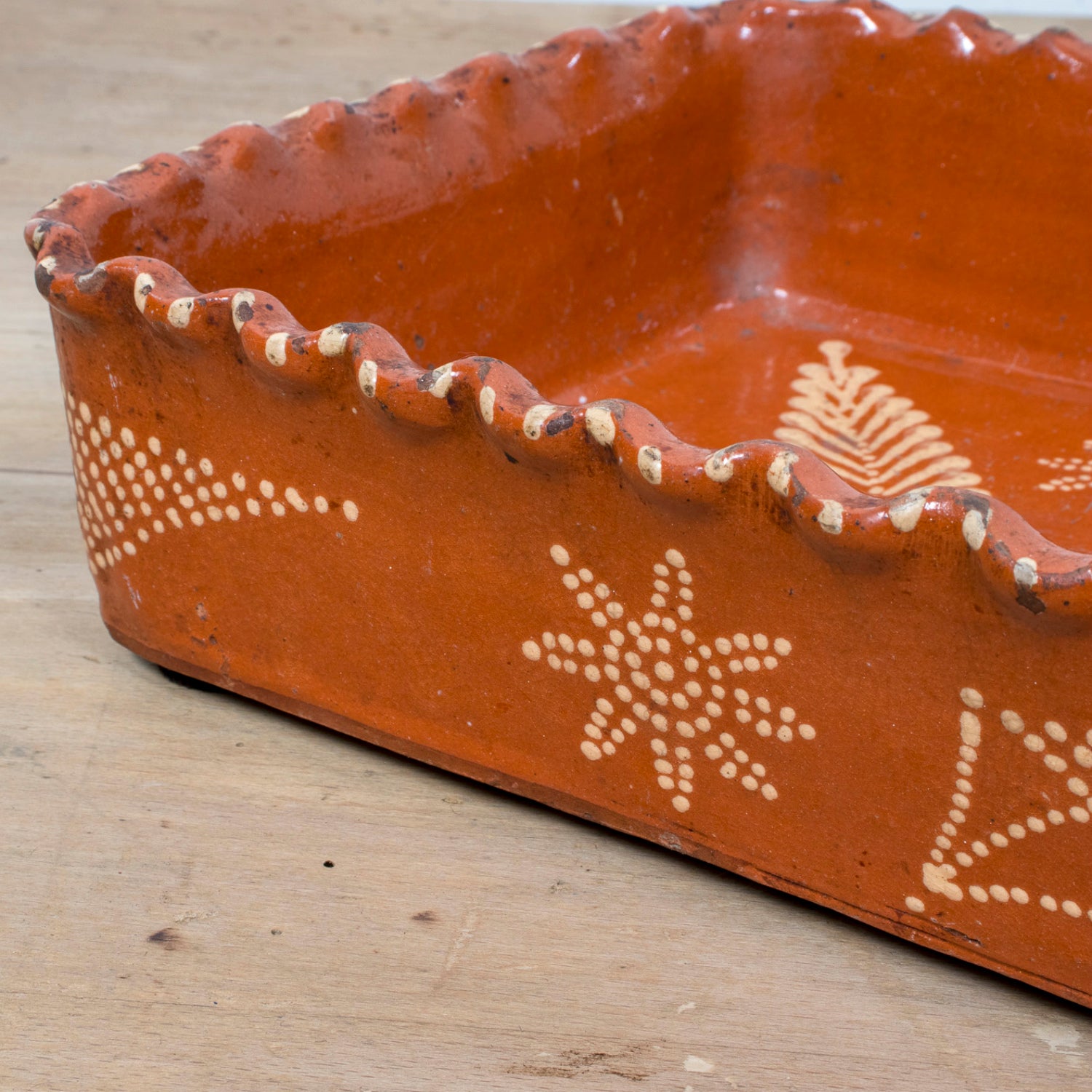 19th Century Portuguese Red Slipware Baking Dish with Fern Leaf Design and Ruffled Edge