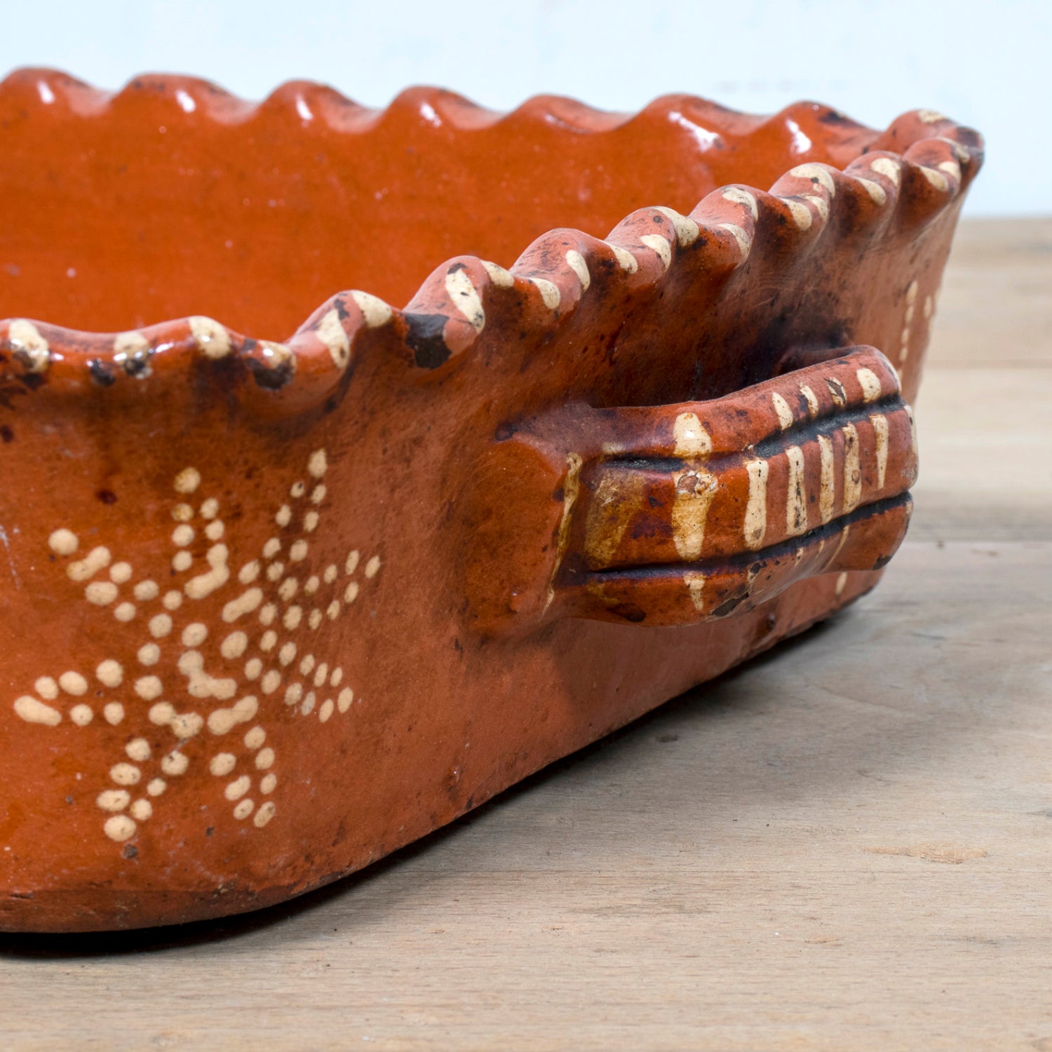 19th Century Portuguese Red Slipware Baking Dish with Fern Leaf Design and Ruffled Edge