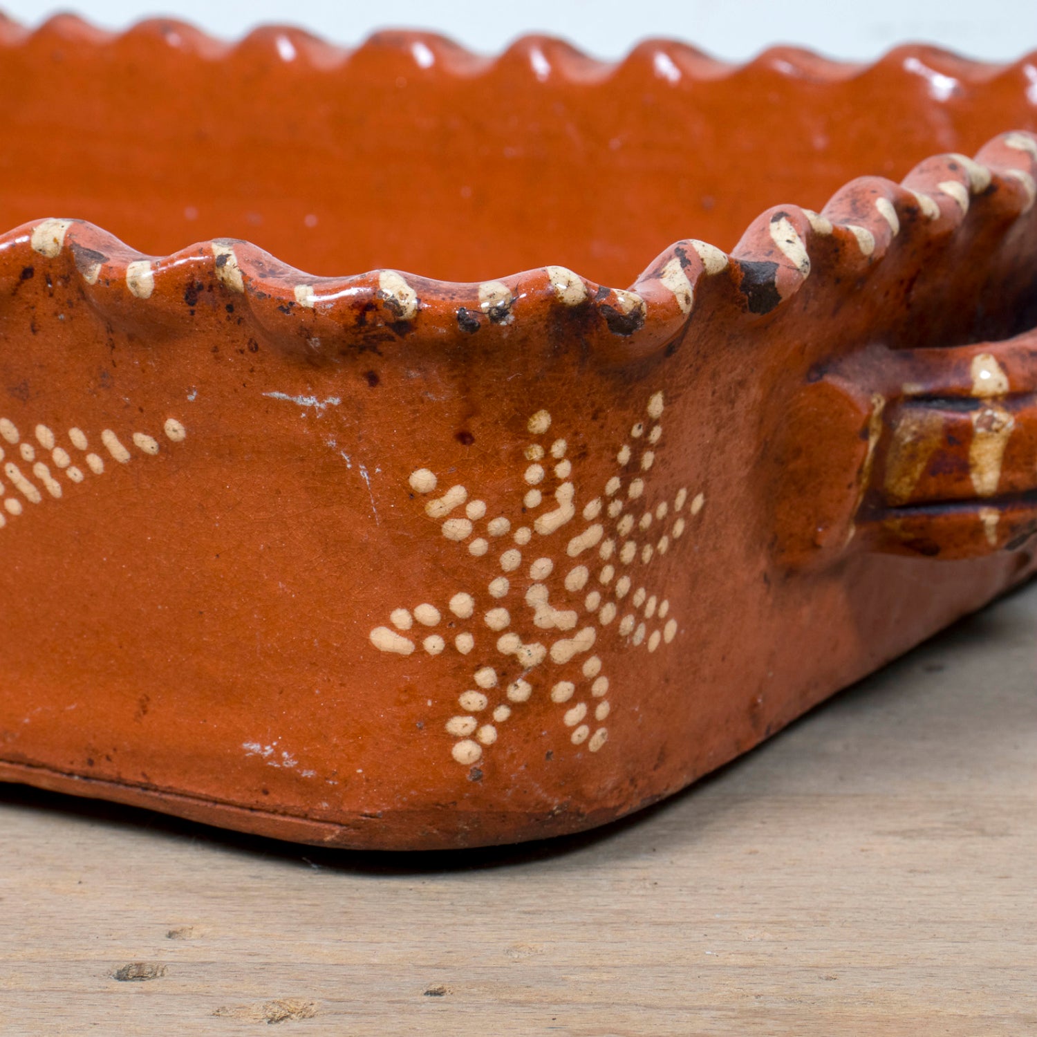 19th Century Portuguese Red Slipware Baking Dish with Fern Leaf Design and Ruffled Edge