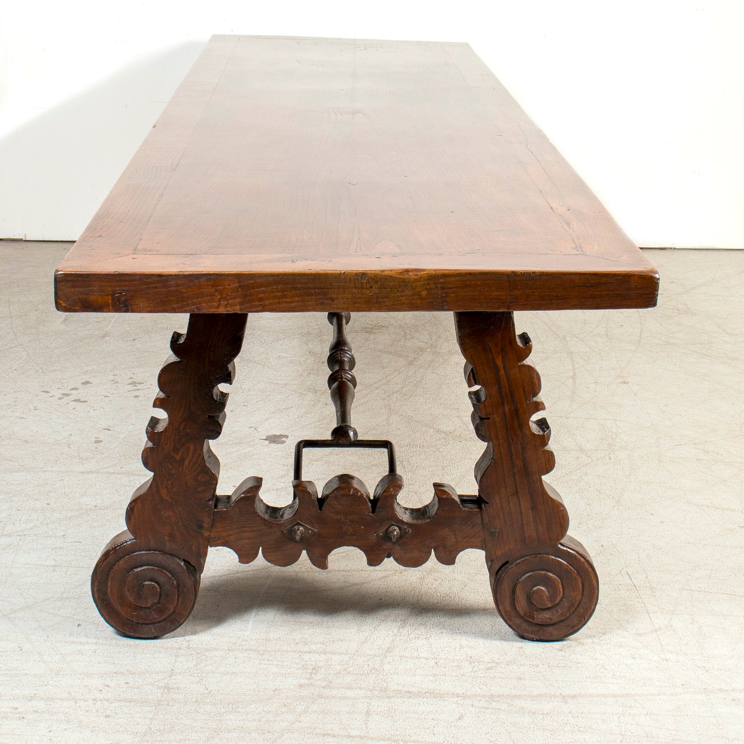 Mid-19th Century Spanish Catalan Carved Oak Dining Trestle Table with Hand Forged Iron Stretcher