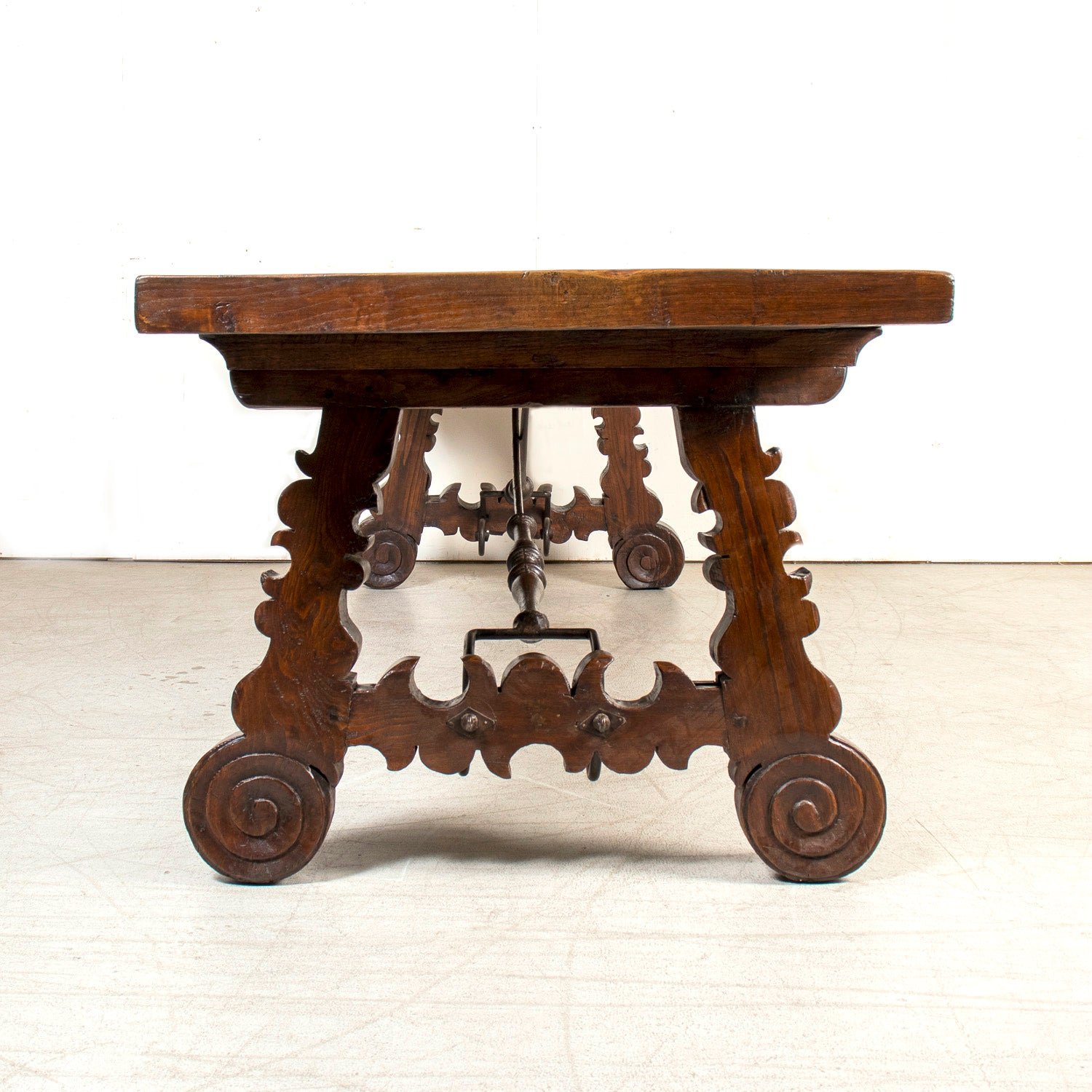 Mid-19th Century Spanish Catalan Carved Oak Dining Trestle Table with Hand Forged Iron Stretcher