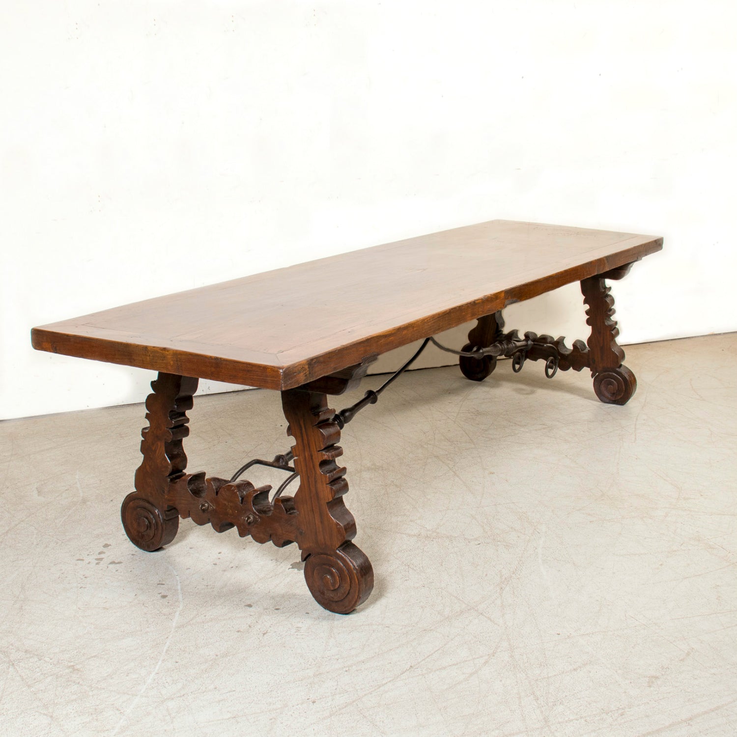 Mid-19th Century Spanish Catalan Carved Oak Dining Trestle Table with Hand Forged Iron Stretcher