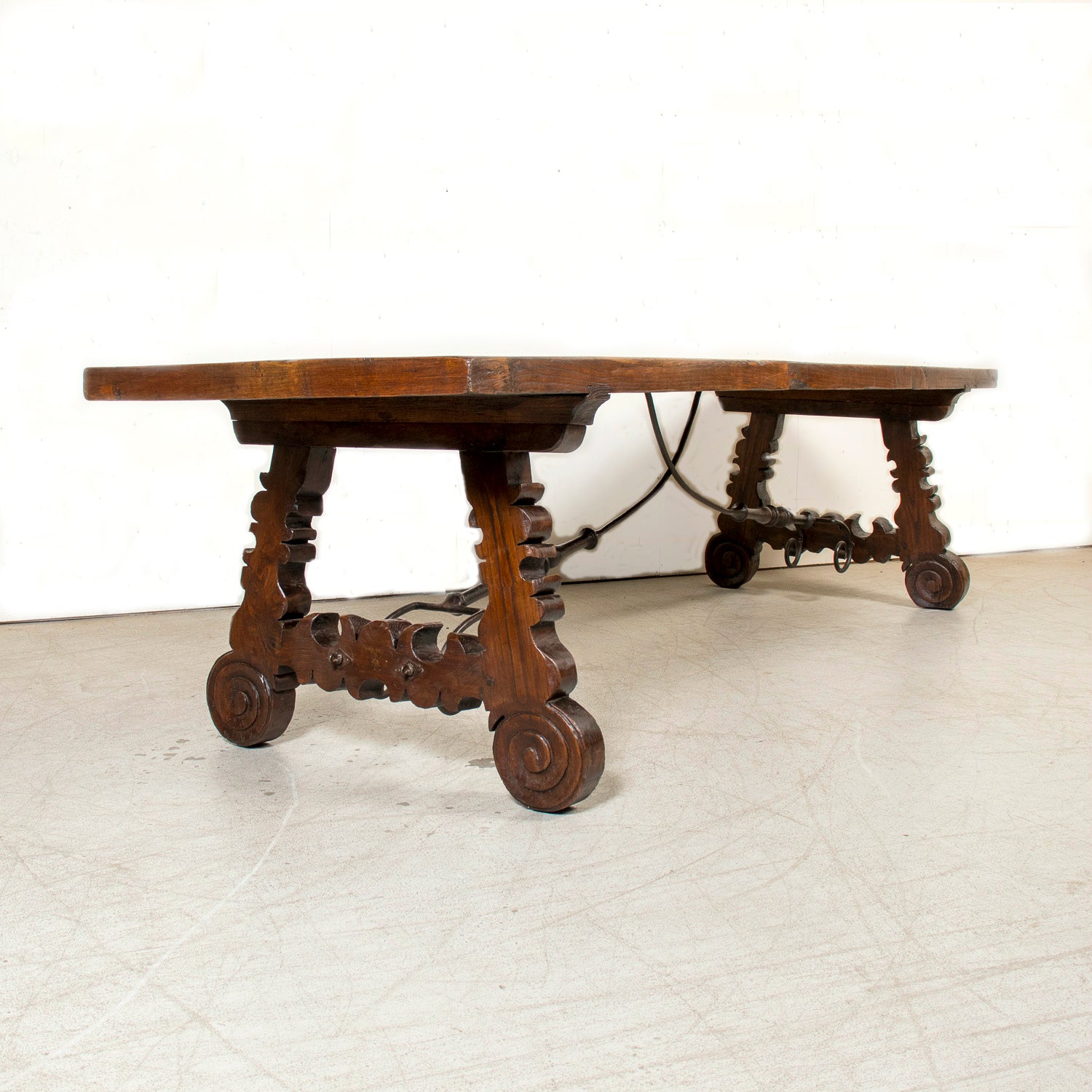 Mid-19th Century Spanish Catalan Carved Oak Dining Trestle Table with Hand Forged Iron Stretcher