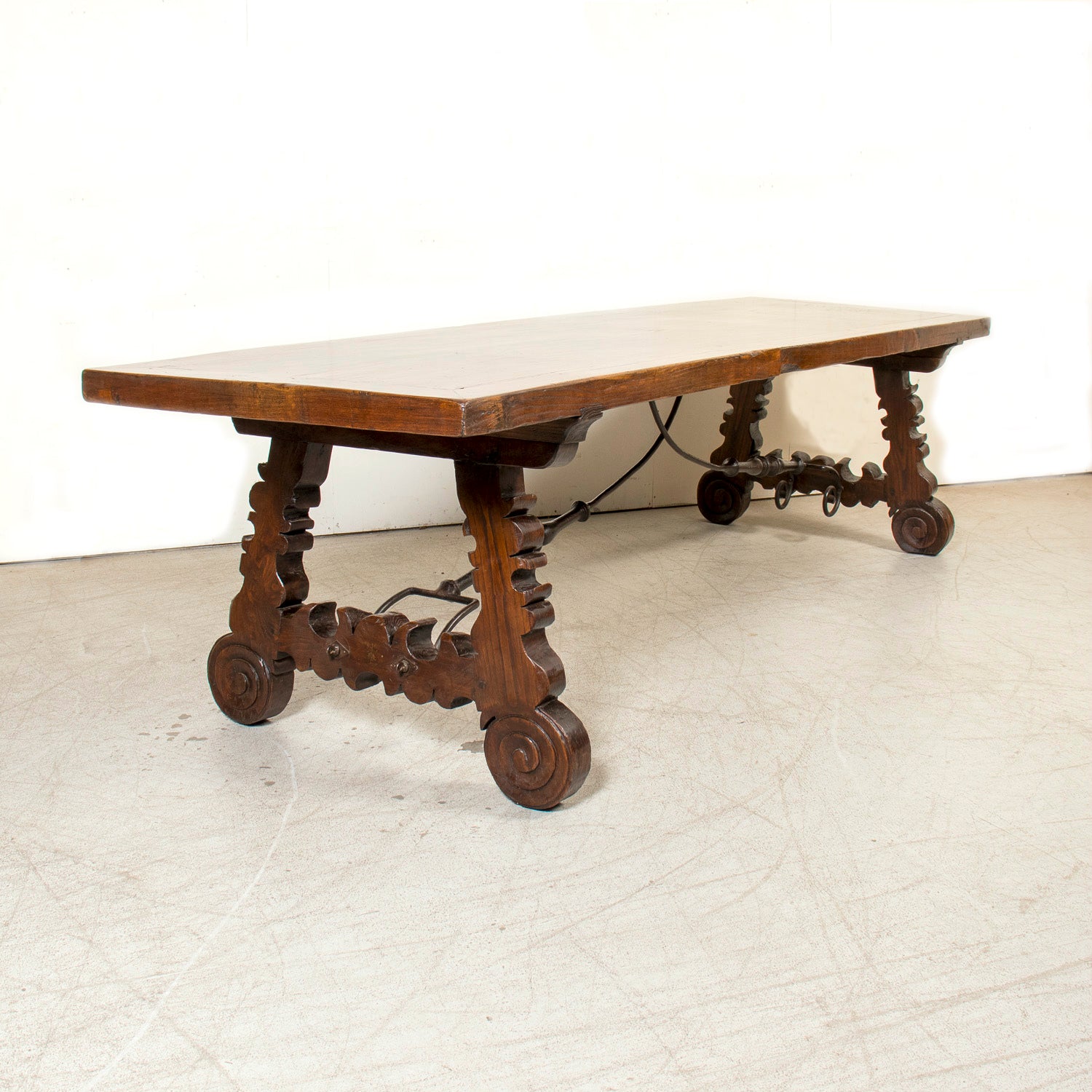 Mid-19th Century Spanish Catalan Carved Oak Dining Trestle Table with Hand Forged Iron Stretcher