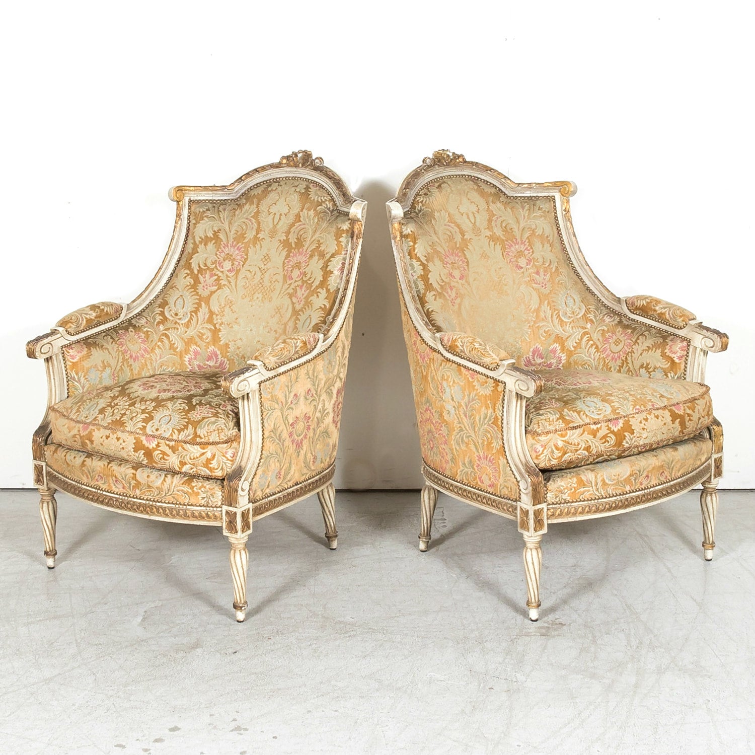 Pair of Early 21st Century French Louis XVI Style Parcel Gilt and Painted Maison Jansen Bergere Armchairs