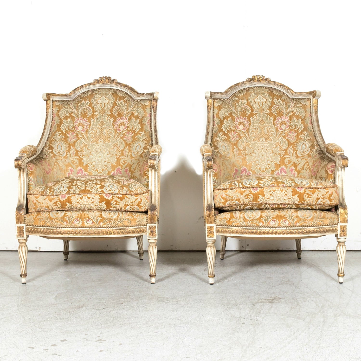 Pair of Early 21st Century French Louis XVI Style Parcel Gilt and Painted Maison Jansen Bergere Armchairs