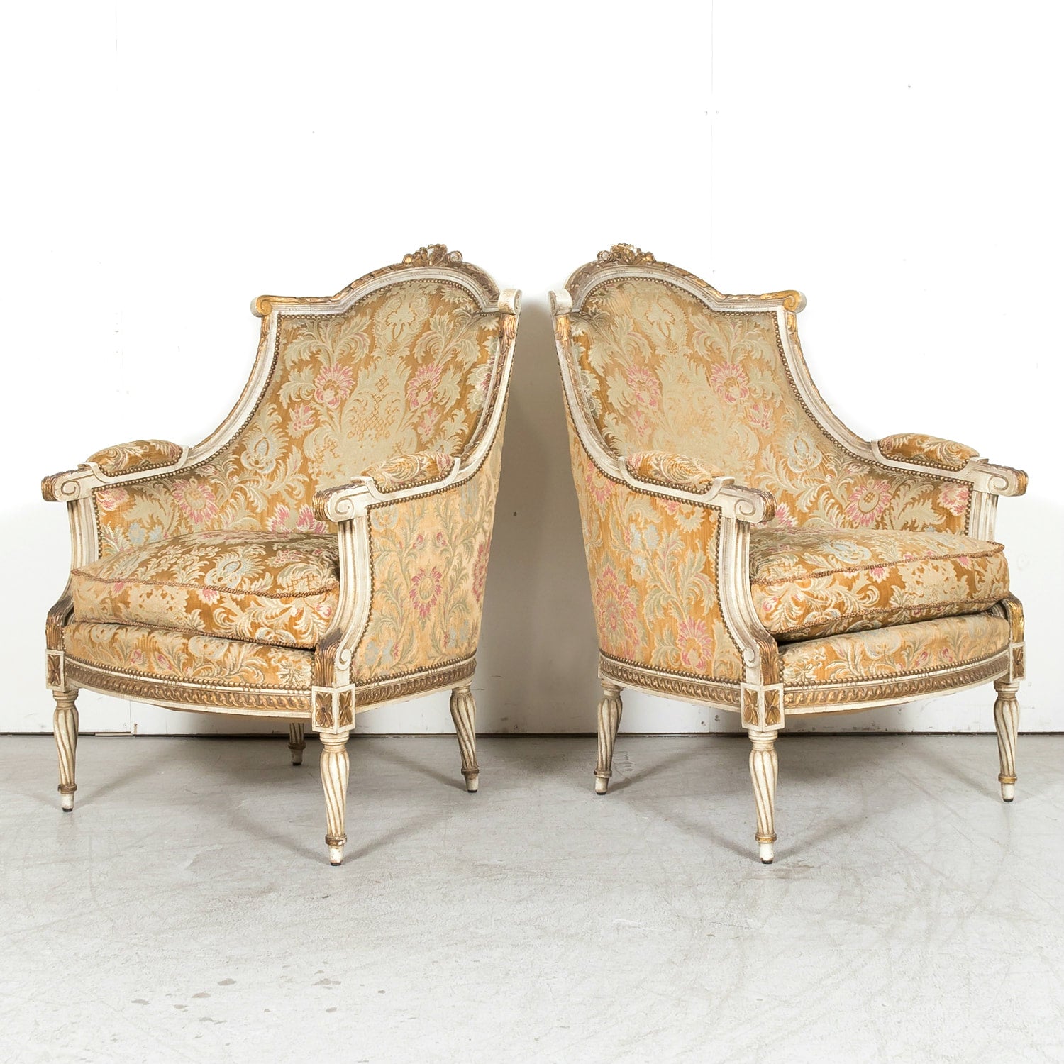 Pair of Early 21st Century French Louis XVI Style Parcel Gilt and Painted Maison Jansen Bergere Armchairs