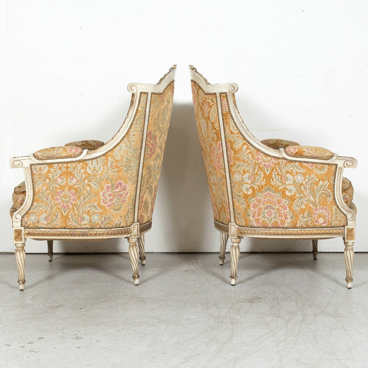 Pair of Early 21st Century French Louis XVI Style Parcel Gilt and Painted Maison Jansen Bergere Armchairs