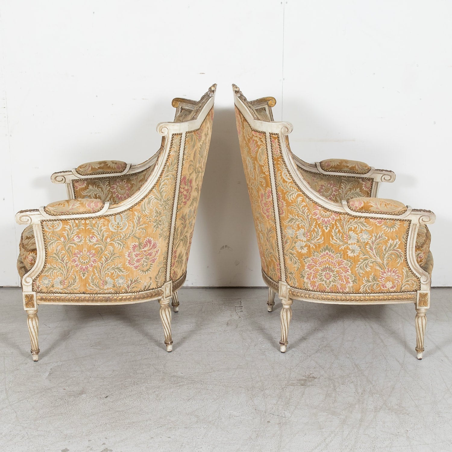 Pair of Early 21st Century French Louis XVI Style Parcel Gilt and Painted Maison Jansen Bergere Armchairs