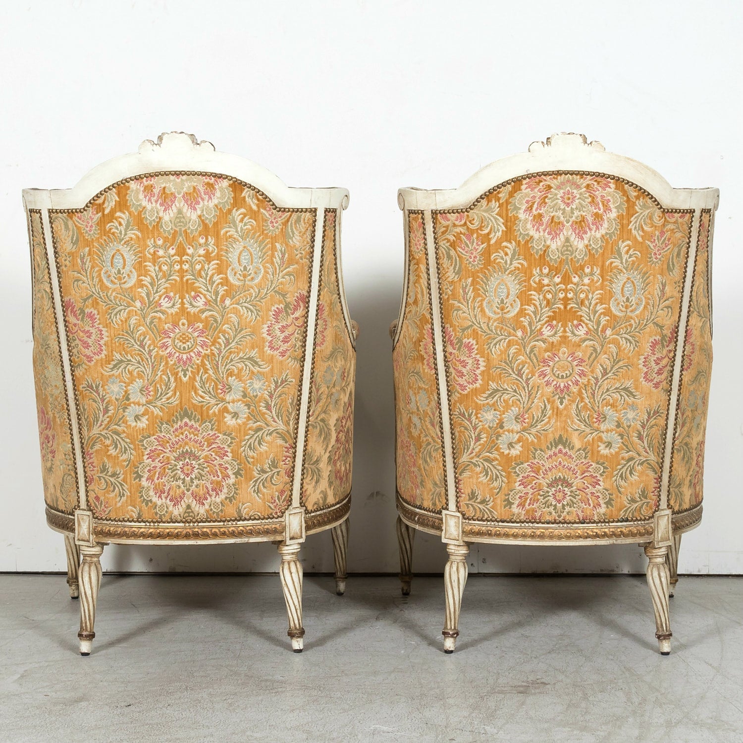 Pair of Early 21st Century French Louis XVI Style Parcel Gilt and Painted Maison Jansen Bergere Armchairs
