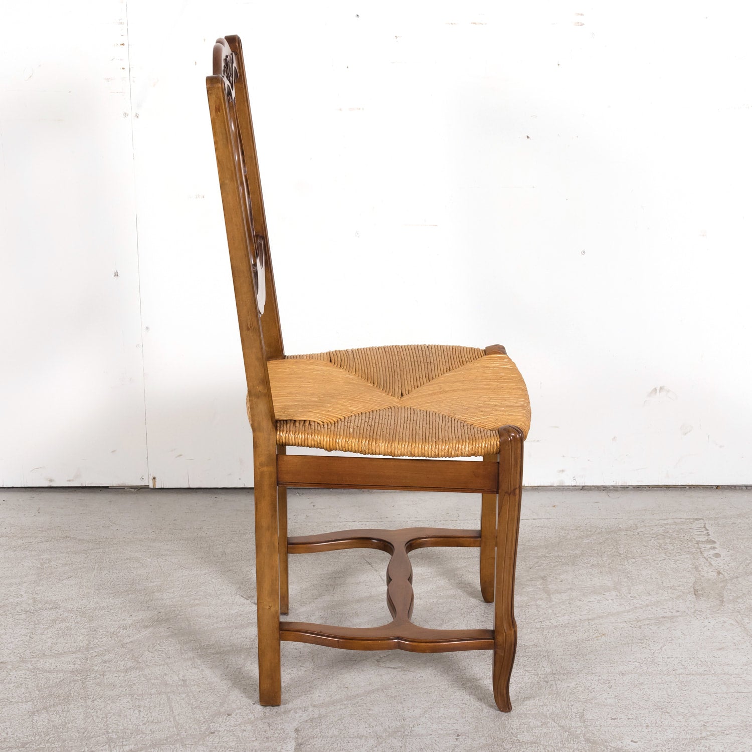 Set of Eight 19th Century Country French Louis XV Style Carved Walnut Dining Side Chairs with Rush Seats