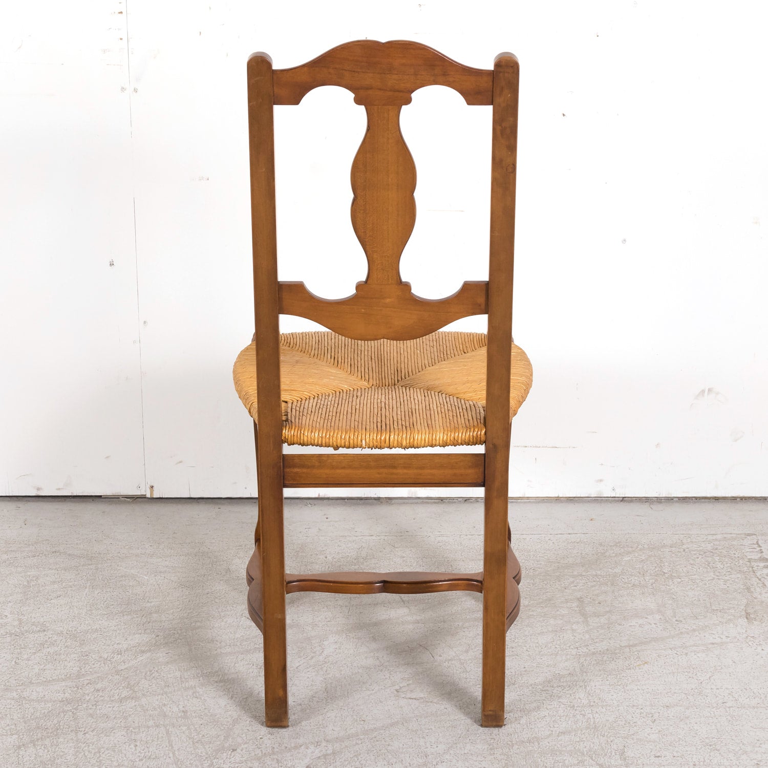 Set of Eight 19th Century Country French Louis XV Style Carved Walnut Dining Side Chairs with Rush Seats