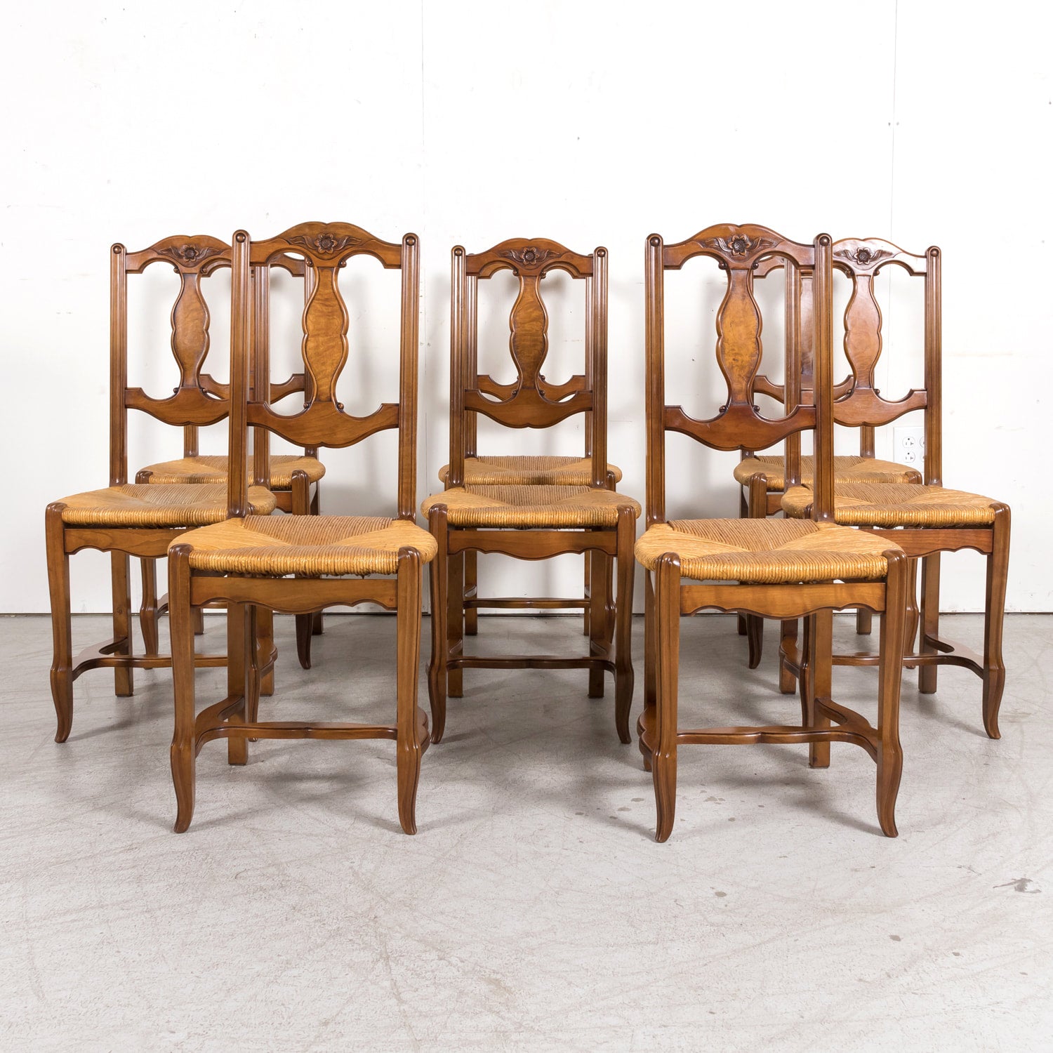 Set of Eight 19th Century Country French Louis XV Style Carved Walnut Dining Side Chairs with Rush Seats